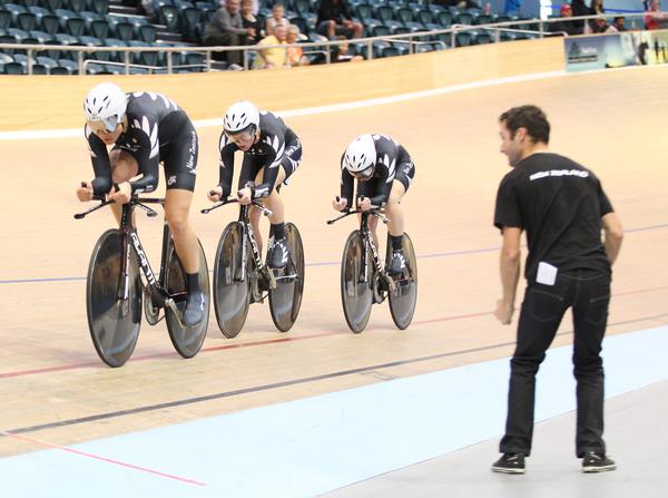 The women's team pursuit trio of (from left) Jaime Nielsen, Alison Shanks and Lauren Ellis with coach Dayle Cheatley calling instructions